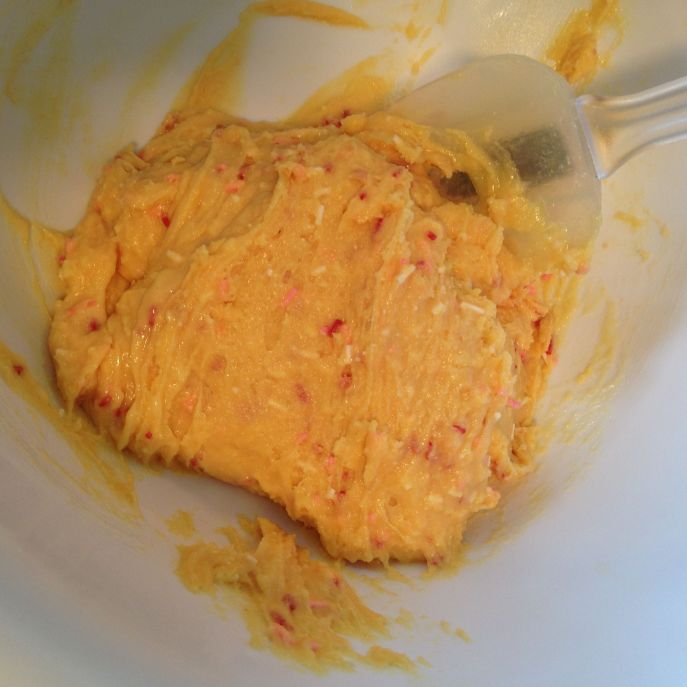 Yellow cake batter sits in a bowl.